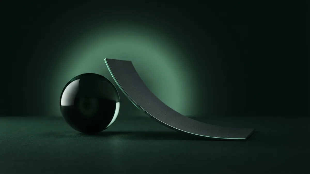 Dark glass sphere and graphite plane on a deep green studio background